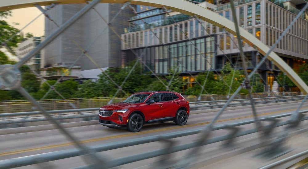 A red 2023 Buick Envision is shown from the front at an angle after leaving a Buick dealer.