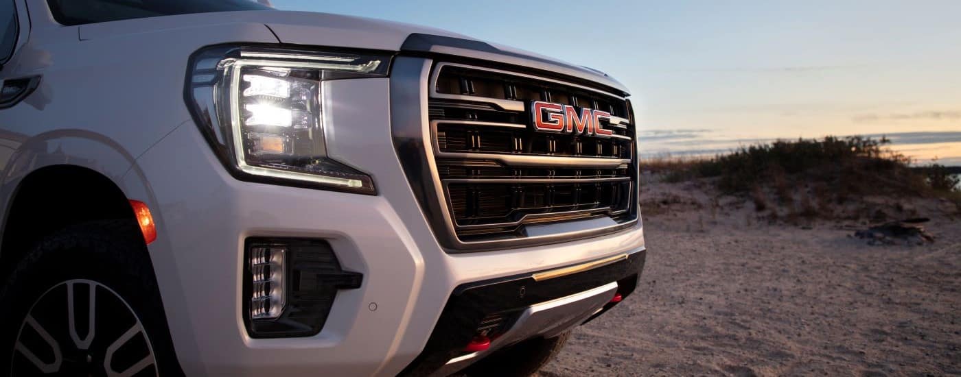 A white 2021 GMC Yukon AT4 is shown in close up after visiting a GMC dealer.
